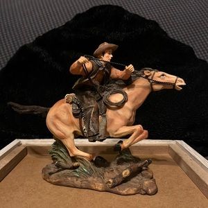 Horse and cowboy figurine.